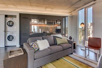 Yard apartments model living room with laundry closet